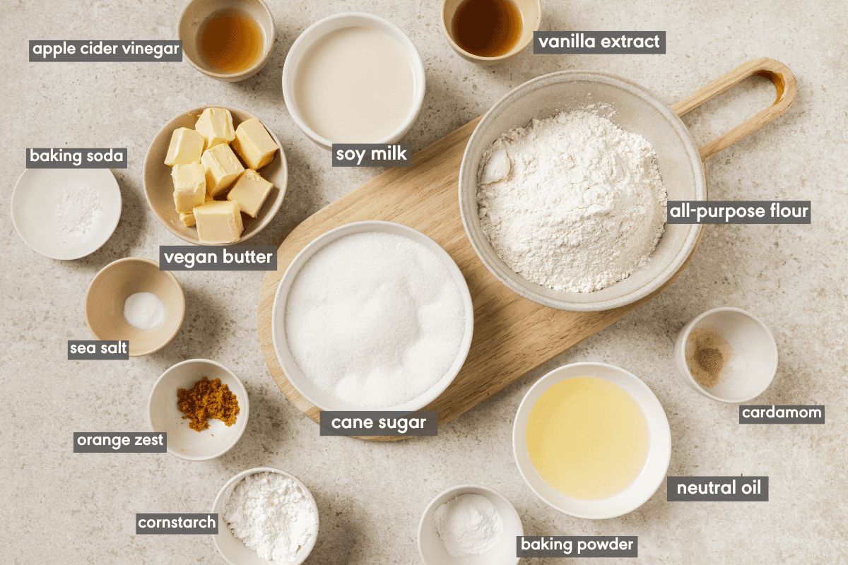 Ingredients for vegan cupcakes in various bowls with ingredients labeled. 